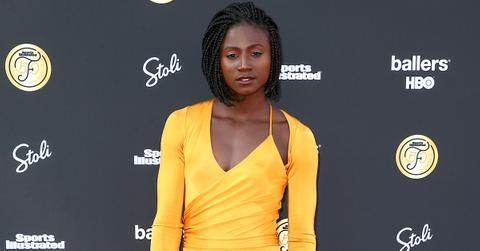 Tori Bowie in a yellow dress