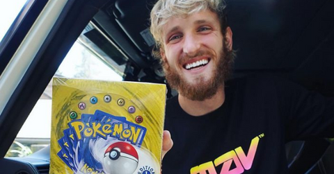 Logan Paul holds Pokemon cards