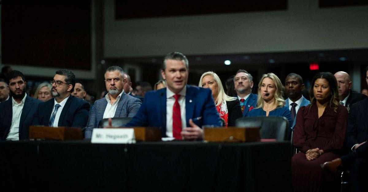 Pete Hegseth with a crowd behind him at a Senate Armed Services Career. 