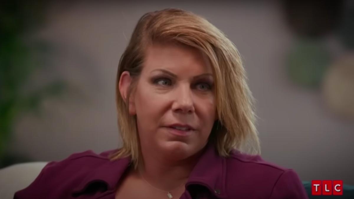 Meri Brown wears a red collared button down shirt and looks apprehensive in an episode of 'Sister Wives'.