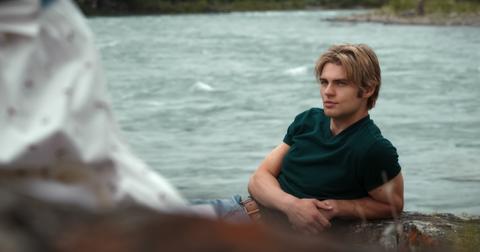 Cole (Noah LaLonde) sitting by the lake in 'My Life With the Walter Boys'