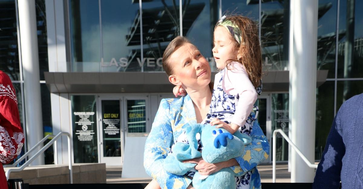 Oksana Baiul holds her daughter after an event supporting peace in Ukraine.