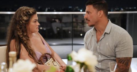 Jax Taylor and Brittany Cartwright talking at a dinner table.