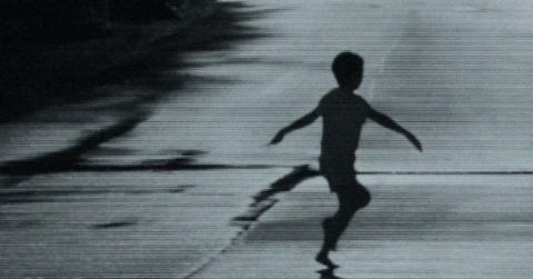 A child in the street in 'Weapons'.