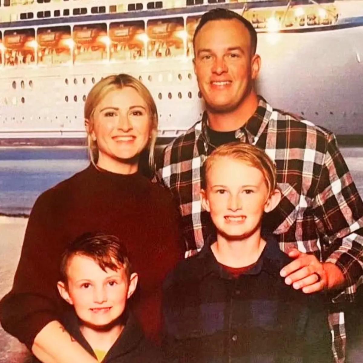 Kay Epps, Randy Epps, their two sons smiling in front of a cruise ship