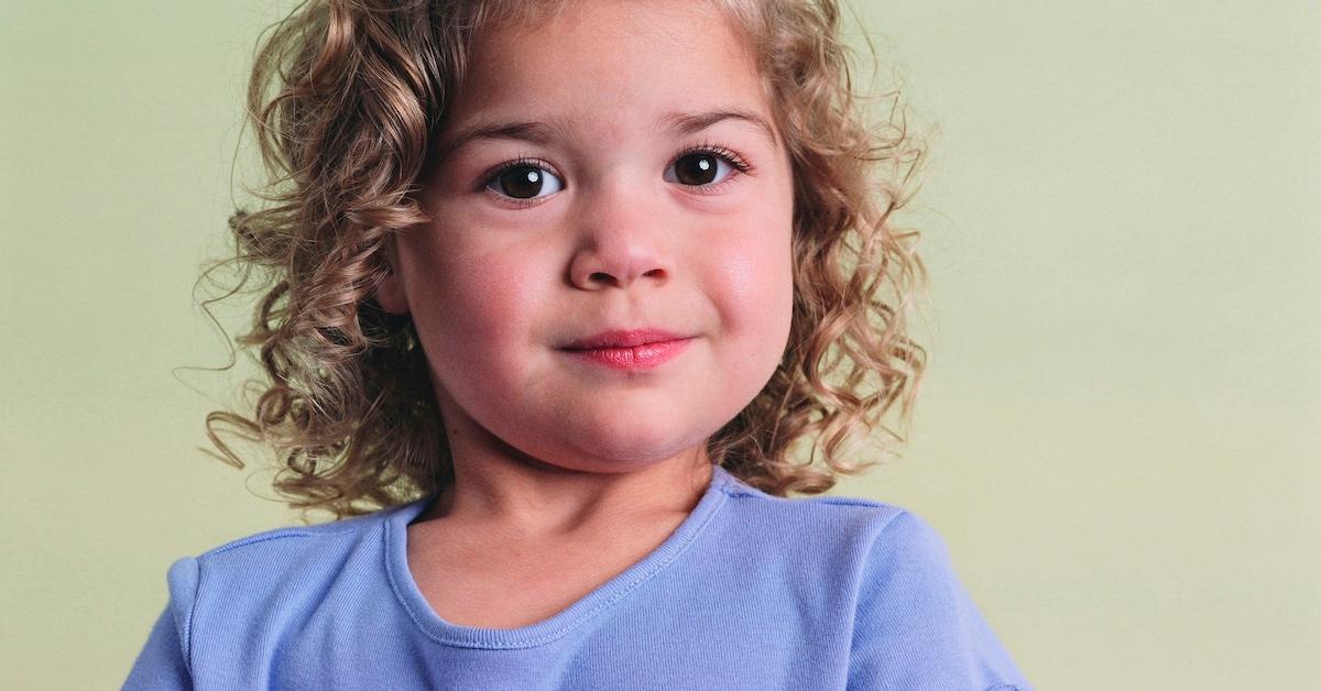 A toddler with curly hair
