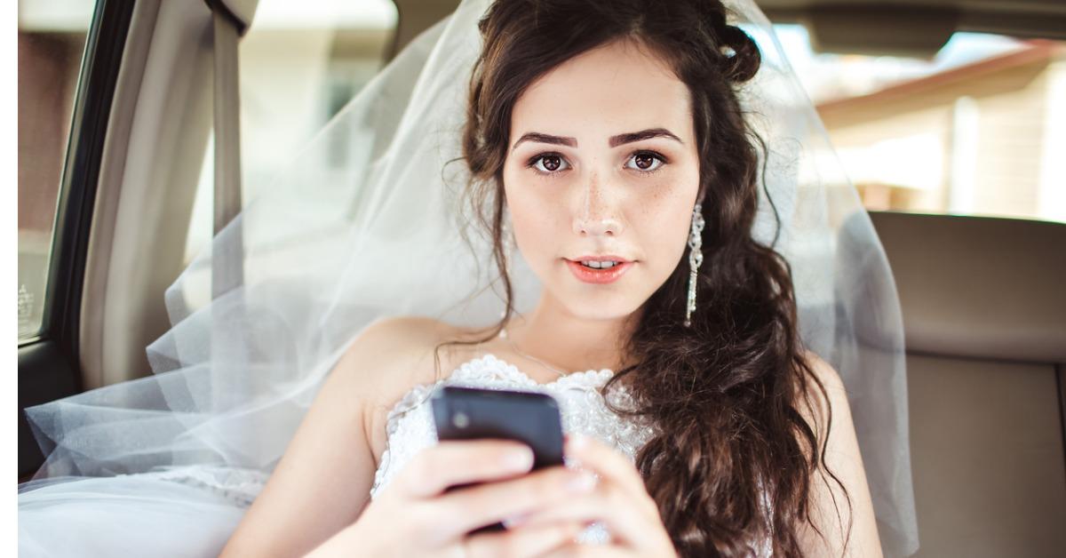 beautiful bride sitting in car straight with mobile phone hairst picture id