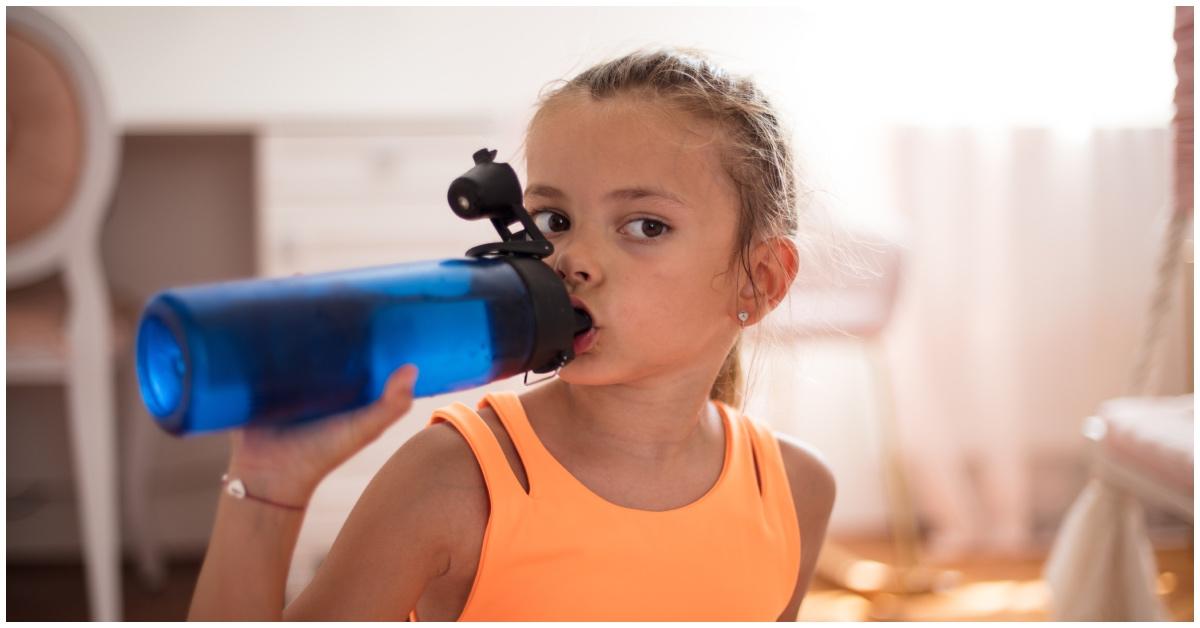 A girl drinking a water bottle