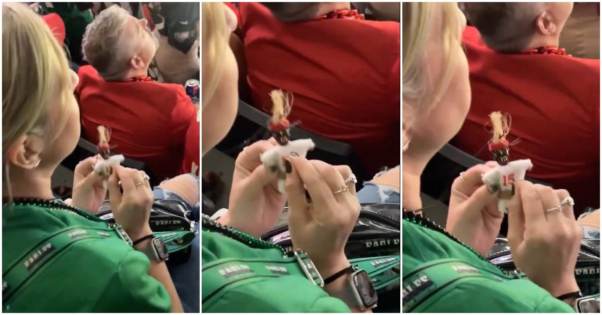 Eagles fan poking a Chiefs voodoo doll at 2025 Super Bowl.