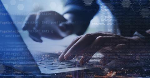 Person typing on a computer using AI