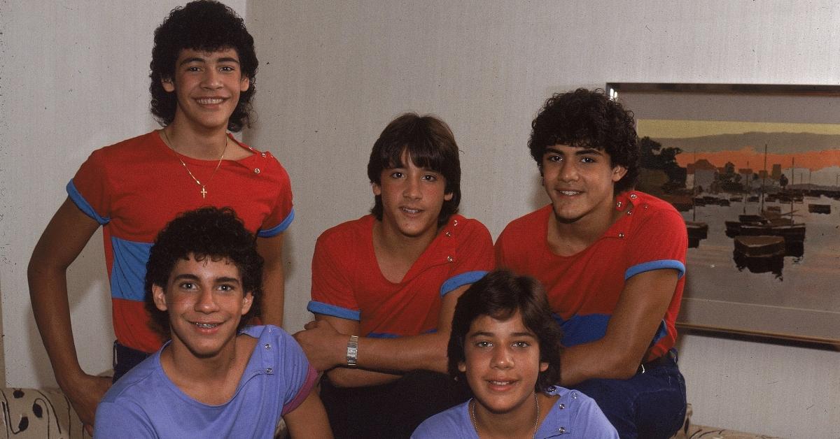 CIRCA MID 1980s: Puerto Rican teen quintet "Menudo" pose in a hotel room for a mid 1980's portrait, including Roy Rosello