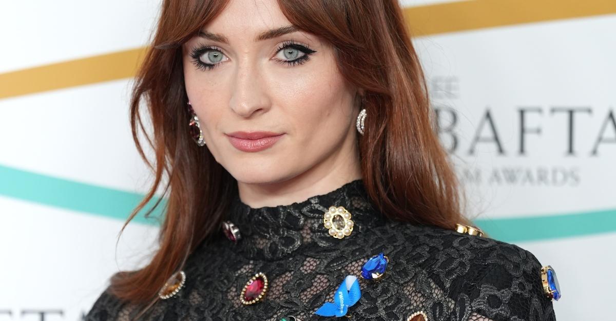 Sophie Turner wearing a blue ribbon at the BAFTA awards 2023