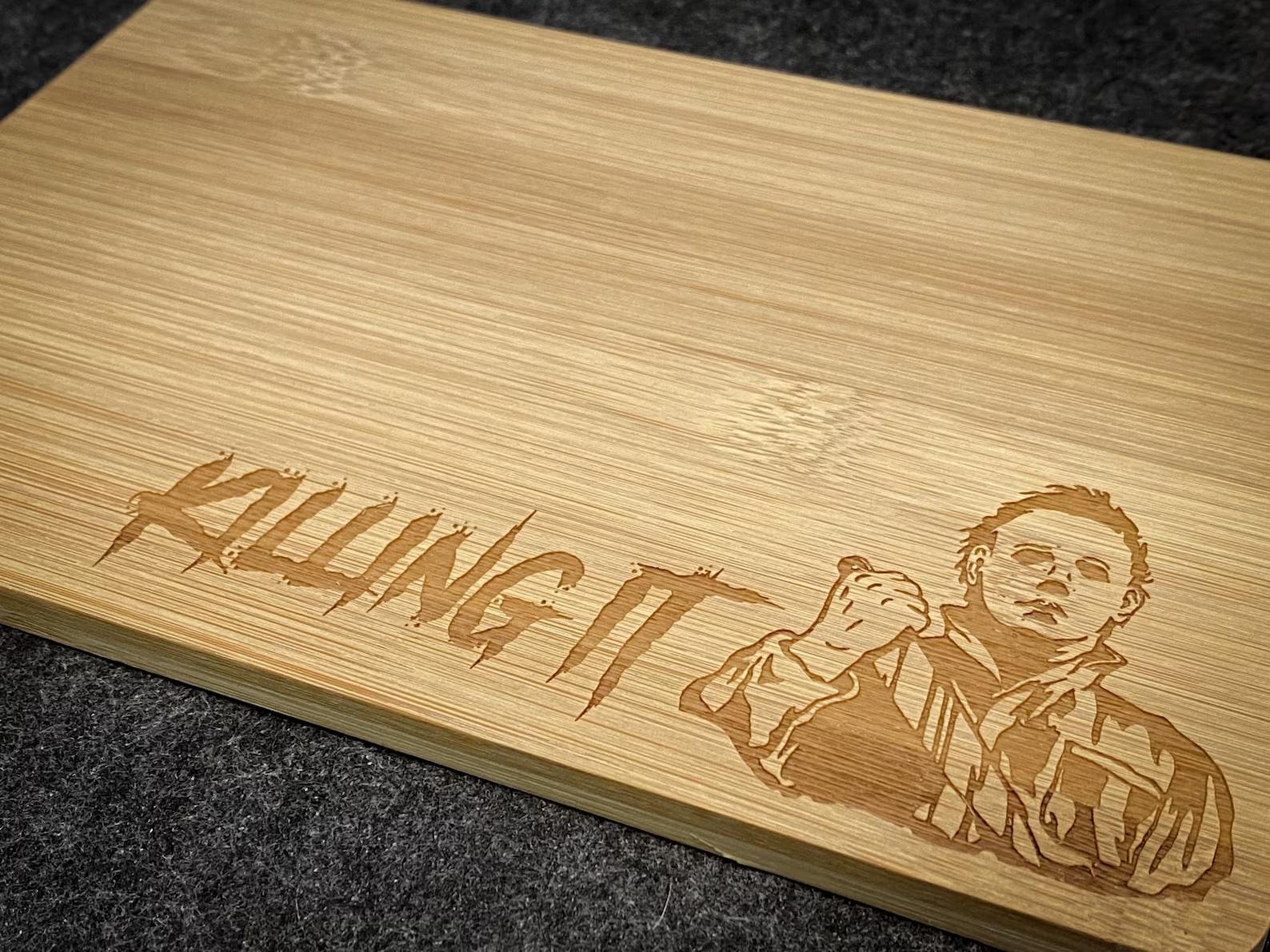 A cutting board engraved with michael myer's face and the words "killing it"