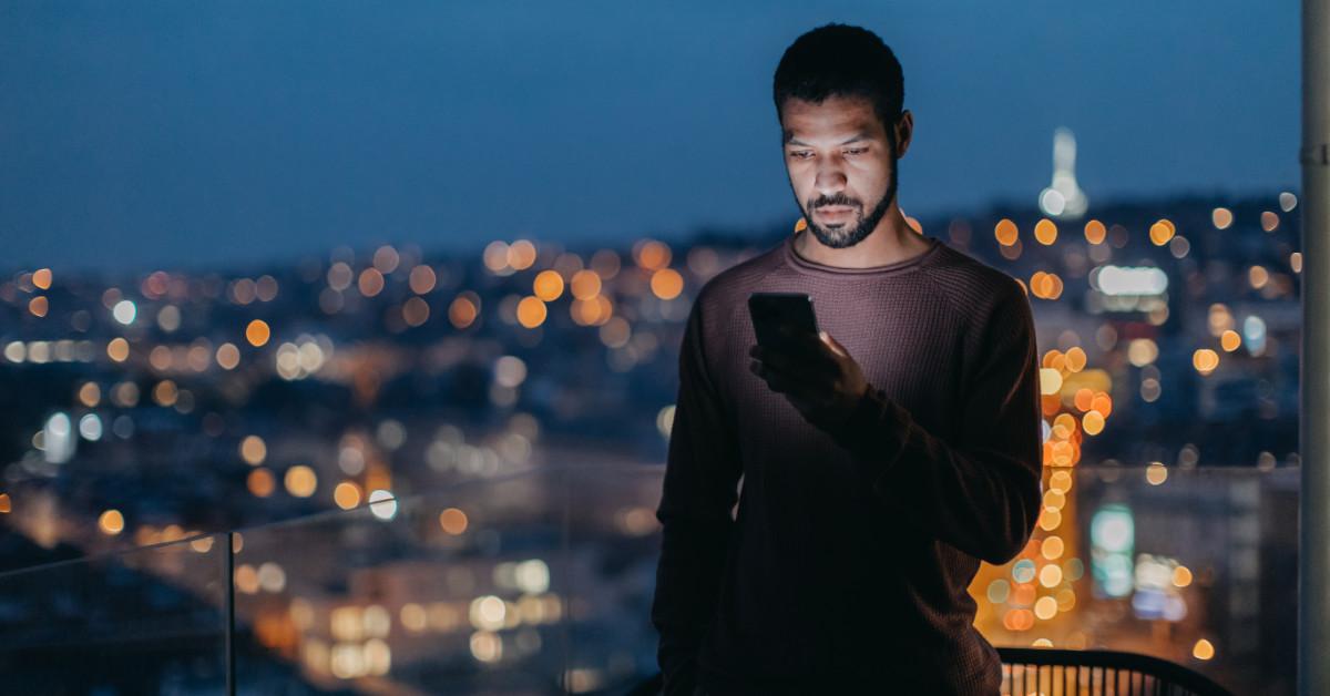 Serious man looking at cell phone