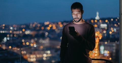 Serious man looking at cell phone