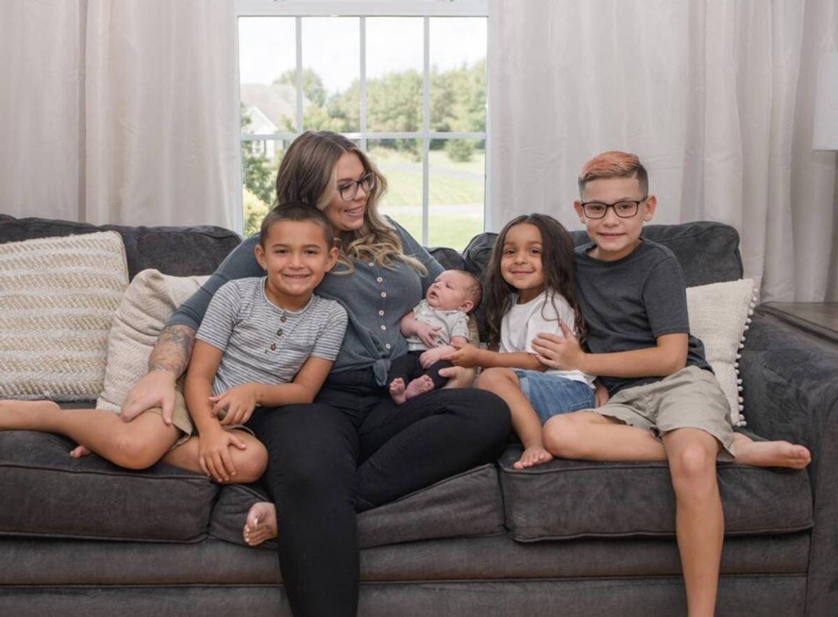 Kailyn posing with all the. boys for a family photo. 