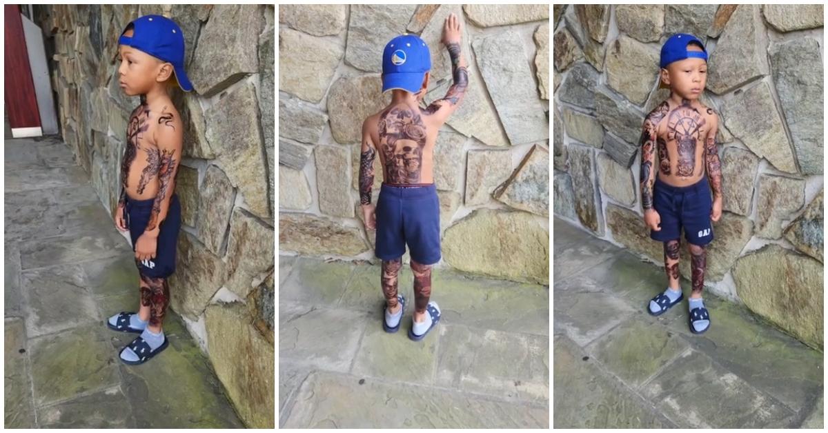 (l-r): A young boy showing off his tattoos. 
