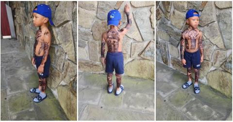 (l-r): A young boy showing off his tattoos.