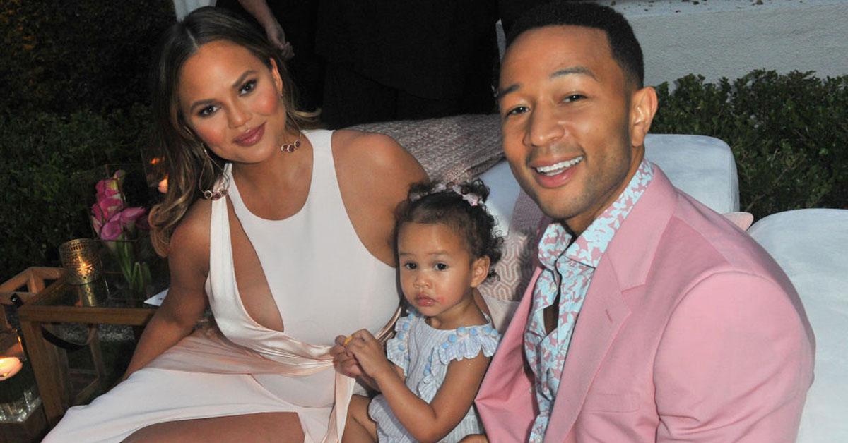 John and Chrissy sit with their daughter Luna.