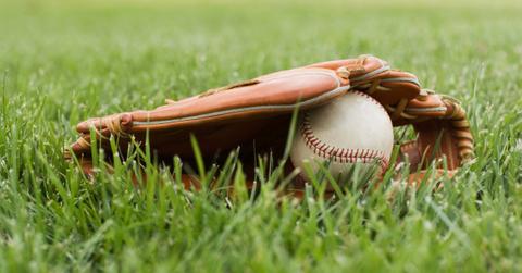 Baseball mitt with ball in grass