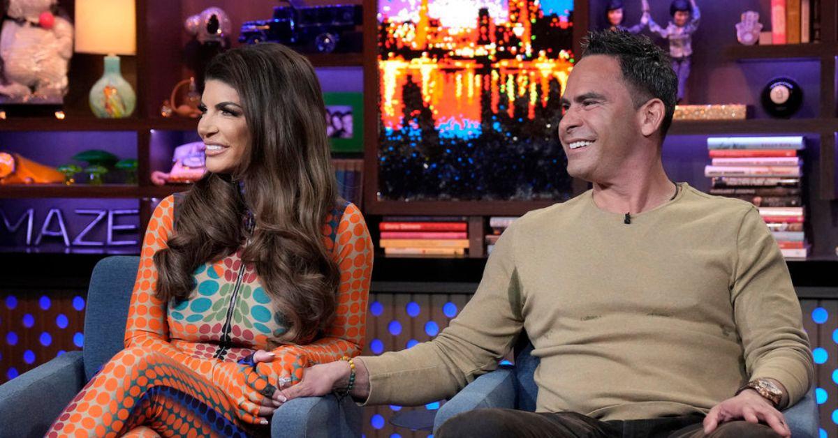 (l-r): Teresa Giudice and Louie Ruelas on 'Watch What Happens Live' holding hands.
