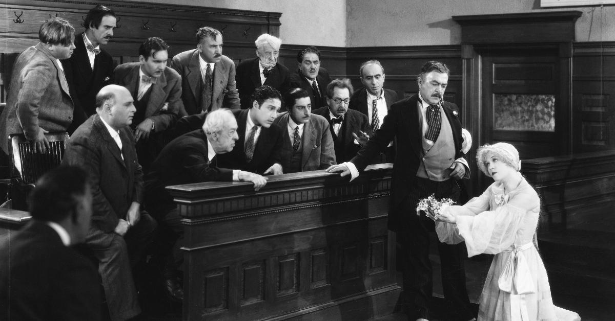 Roxie Hart (Phyllis Haver, right) pleads with the jury during her murder trial as her lawyer Flynn (Robert Edeson) looks on in a scene from Chicago (1927)