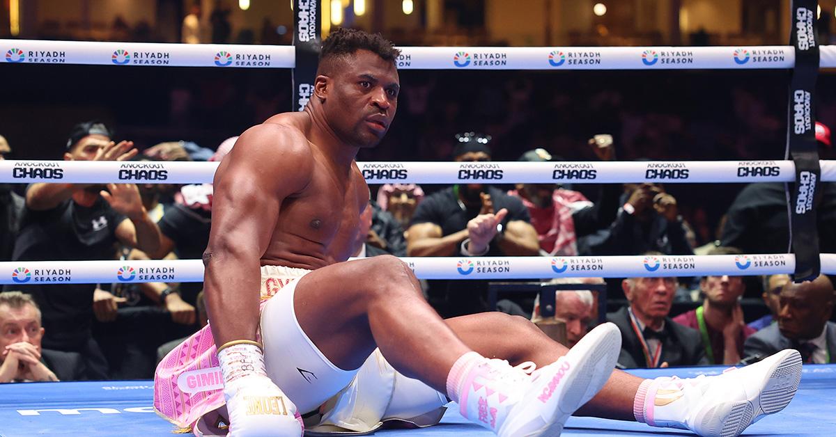 Francis Ngannou sitting in the boxing ring. 