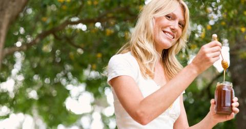 Woman with a jar of honey