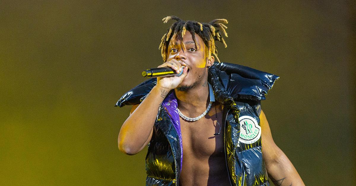 Juice Wrld performing on stage in a vest. 