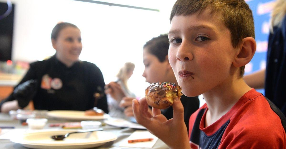 kid eating a doughnut