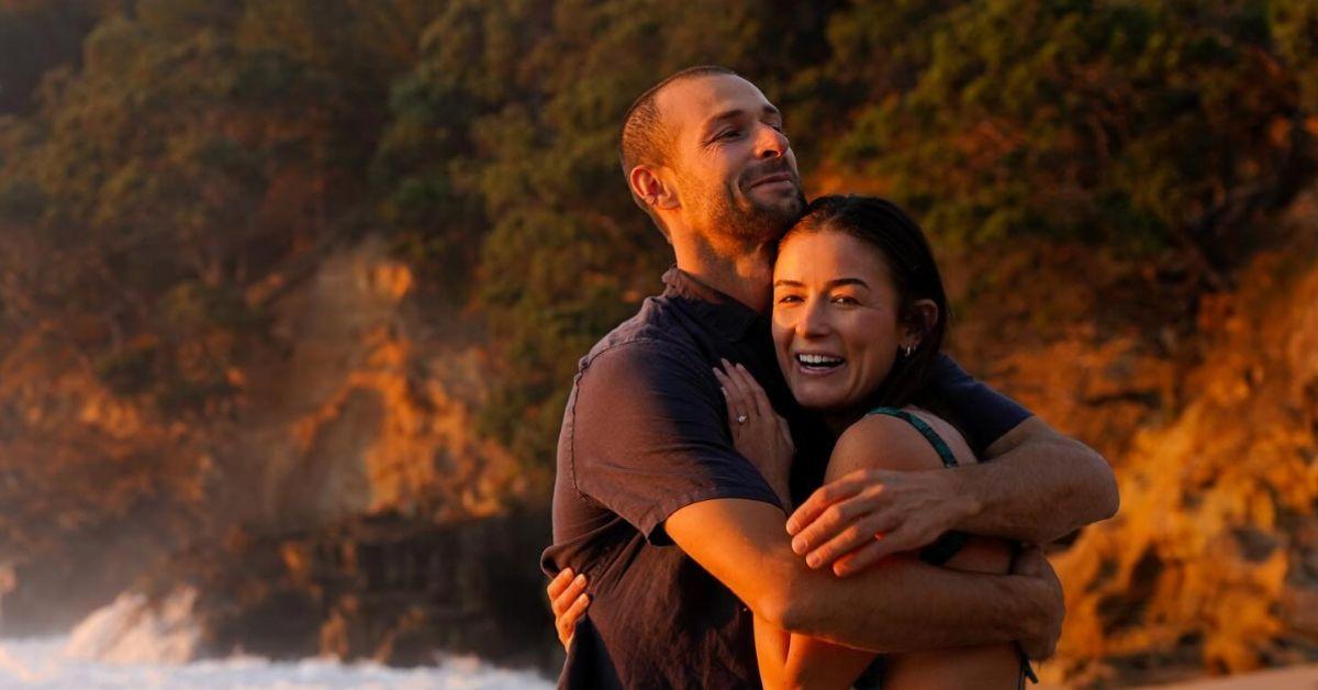 Scott "Scotty" Dobson holds Aesha Scott after proposing to her on the beach.