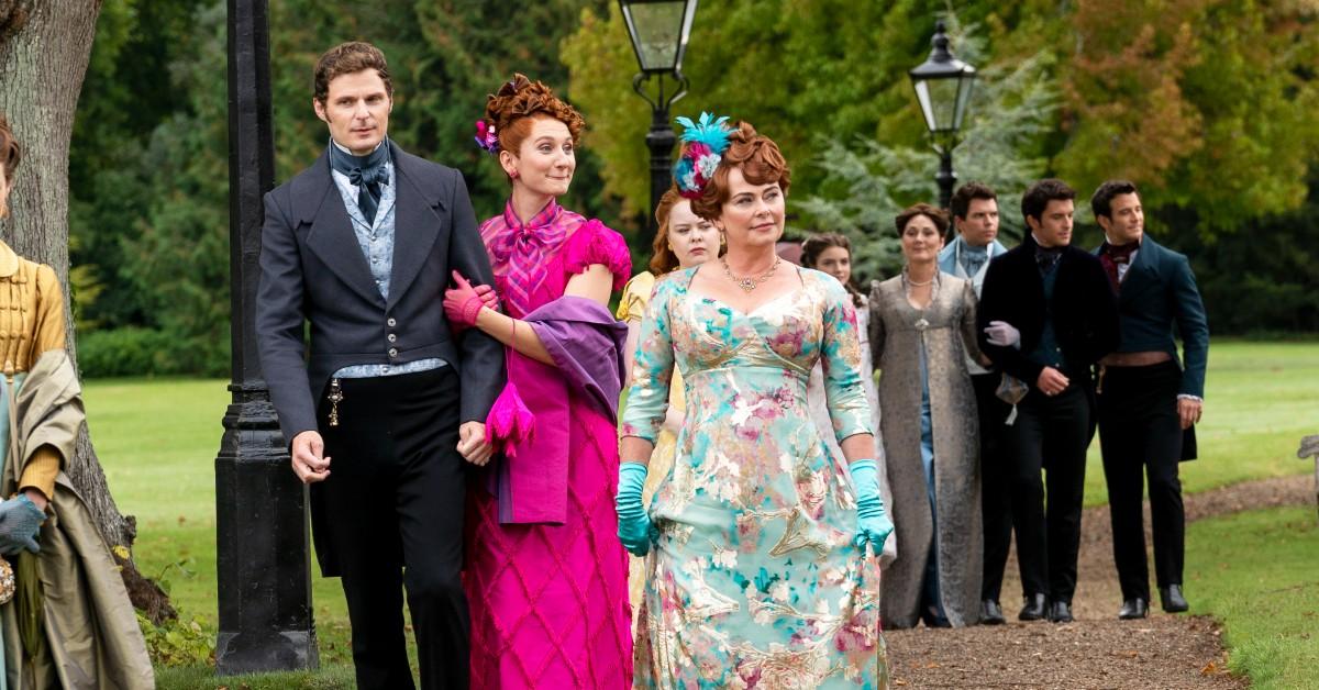 (L to R) Rupert Young as Lord Jack Featherington, Bessie Carter as Prudence Featherington, Nicola Coughlan as Penelope Featherington, Polly Walker as Lady Portia Featherington, Florence Emilia Hunt as Hyacinth Bridgerton, Ruth Gemmell as Lady Violet Bridgerton, Luke Newton as Colin Bridgerton, Jonathan Bailey as Anthony Bridgerton, Luke Thompson as Benedict Bridgerton