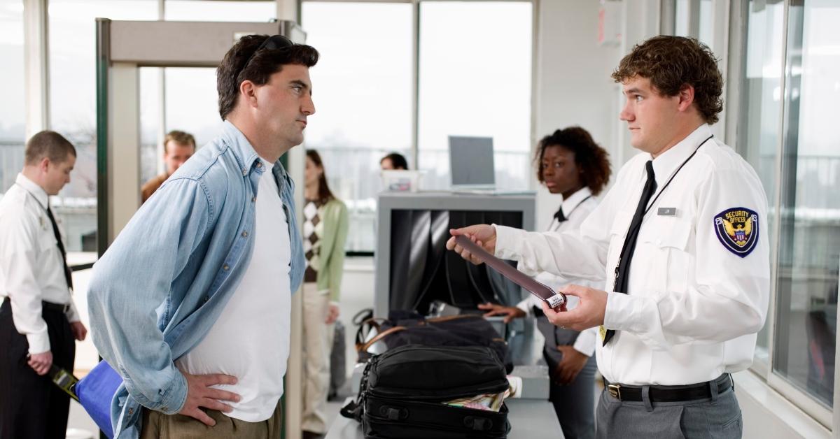 Security guard and man at airport 