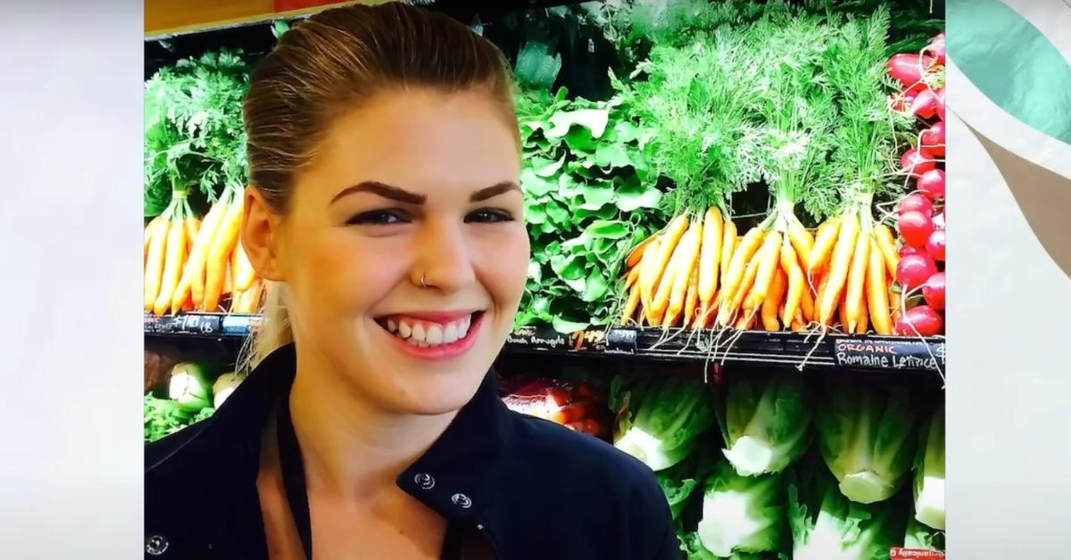 Belle Gibson smiles at a grocery store