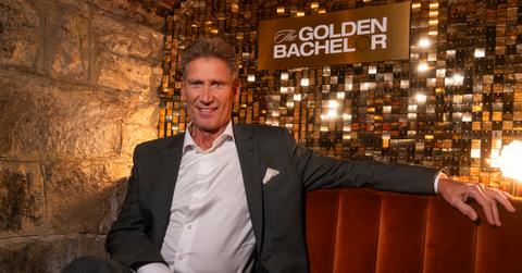 Gerry Turner sits in front of a Golden Bachelor sign