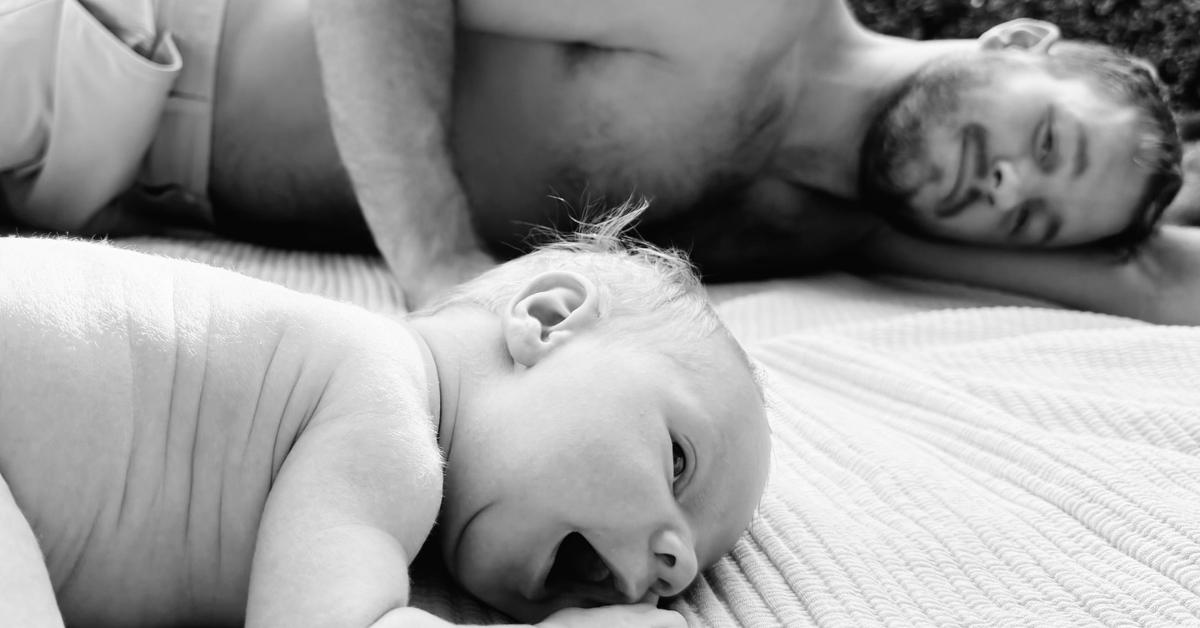 Colton Underwood and his son, Bishop, lay on the floor.