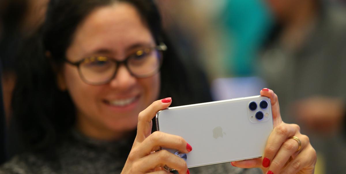 Customers look at the latest iPhone models at Apple Store on September 20, 2019