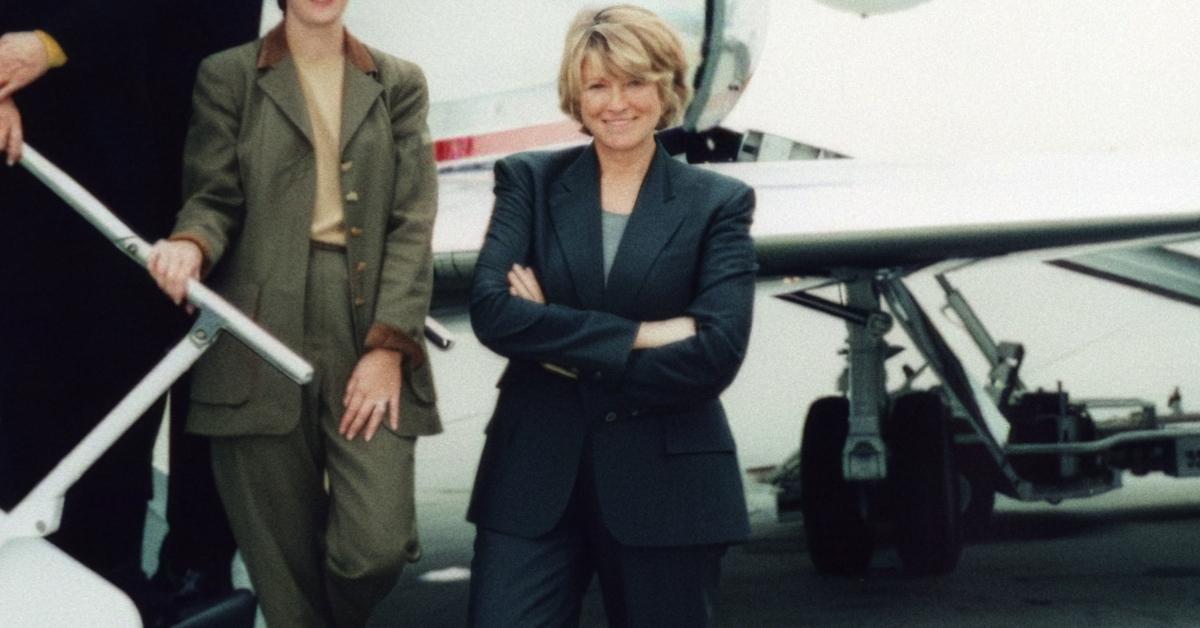 Martha Stewart stands outside of a private plane