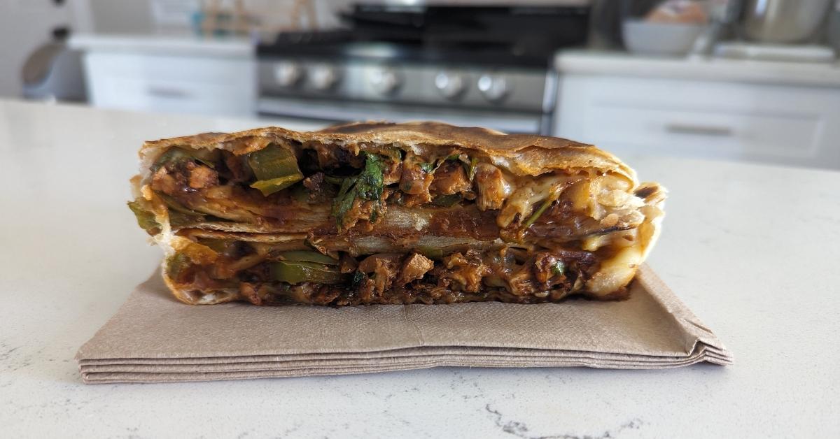 Chicken al Pastor quesadilla cut in half