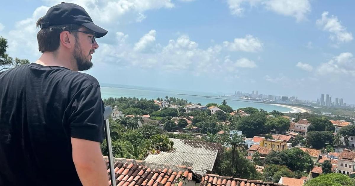 Colt on crutches in Brazil on a rooftop patio.