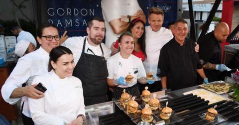 Chef and television personality Gordon Ramsay (3rd R) poses with chefs at his Gordon Ramsay Burger booth