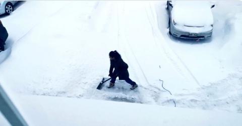 Cynthia Reyes shovels driveway