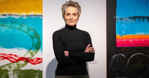 Actress Sharon Stone stands among her works at the Deschler Gallery in the Mitte district. The Hollywood star has been painting for years and now her paintings can be seen in Berlin. Photo: Monika Skolimowska/dpa (Photo by Monika Skolimowska/picture alliance via Getty Images)