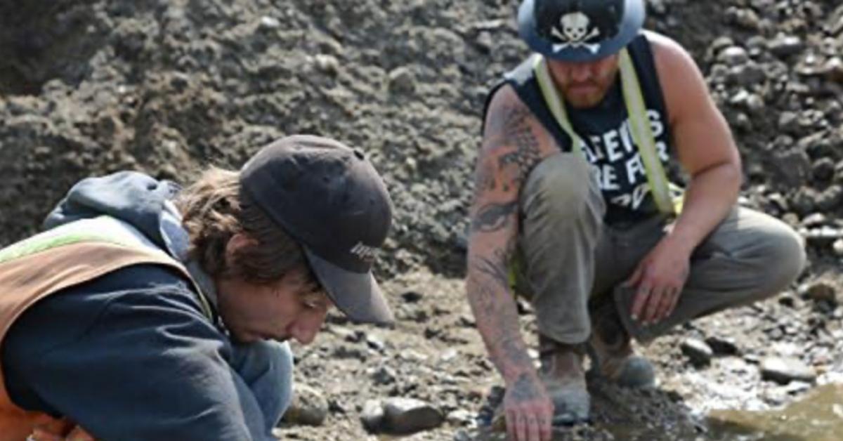 Parker Schnabel and a crew member digging.