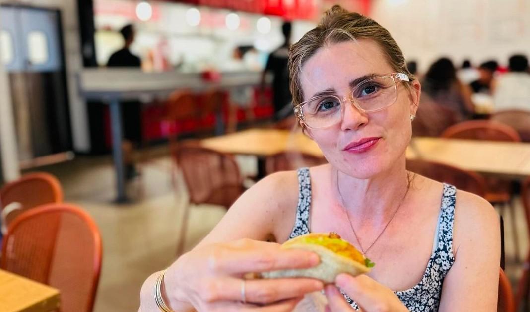 Alison Lohman eating a taco while wearing glasses