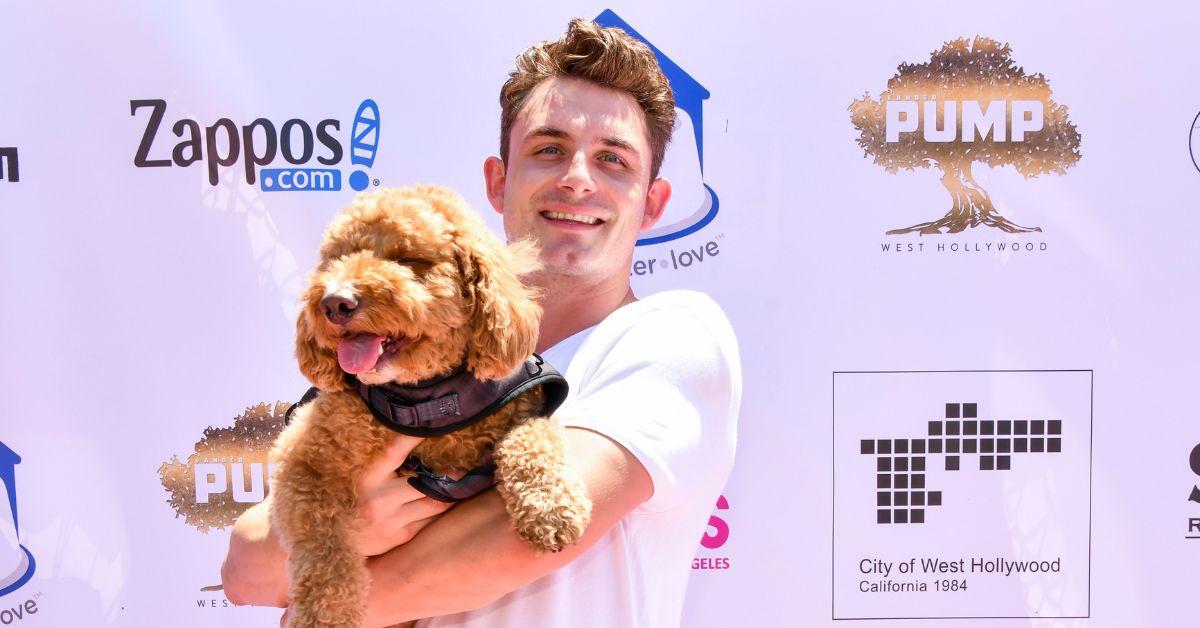 James Kennedy holding Hippie at a daytime red carpet event