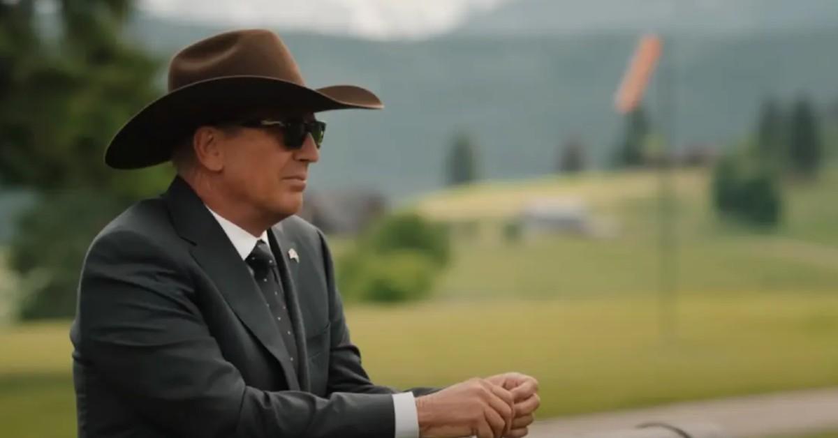 John Dutton (Kevin Costner) wears a grey suit and brown cowboy hat in 'Yellowstone' 