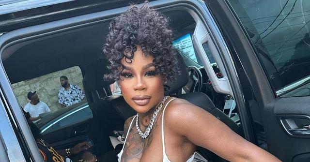 Sukihana sits in a car with the door open.