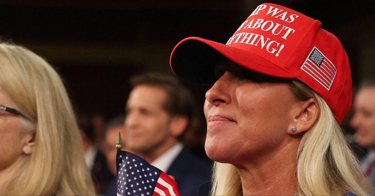 Marjorie Taylor Greene wears a red MAGA hat with a new message. 