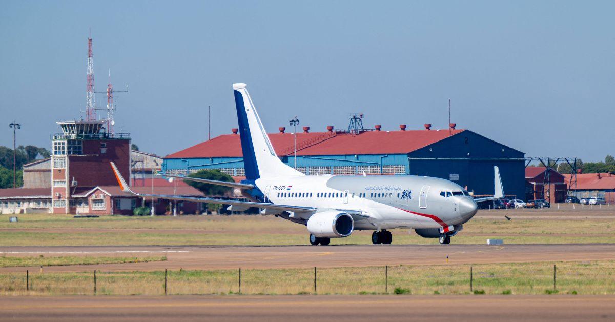 A plane taxiing on a tarmac.